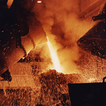 Pouring molten steel from a crucible